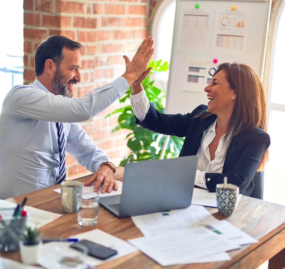 Feedback form image. Man and woman giving five each other, man is using laptop